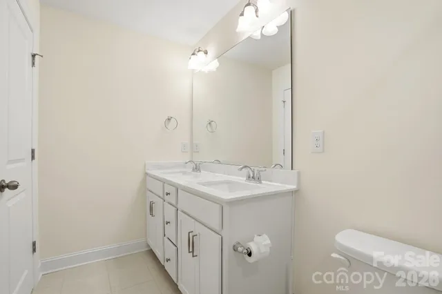 a bathroom with a double vanity sink and mirror