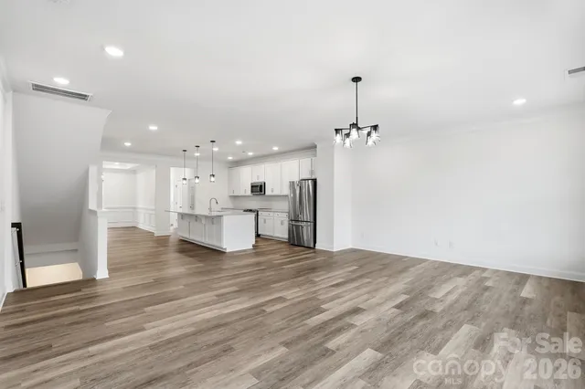 a view of a kitchen with a sink and chandelier