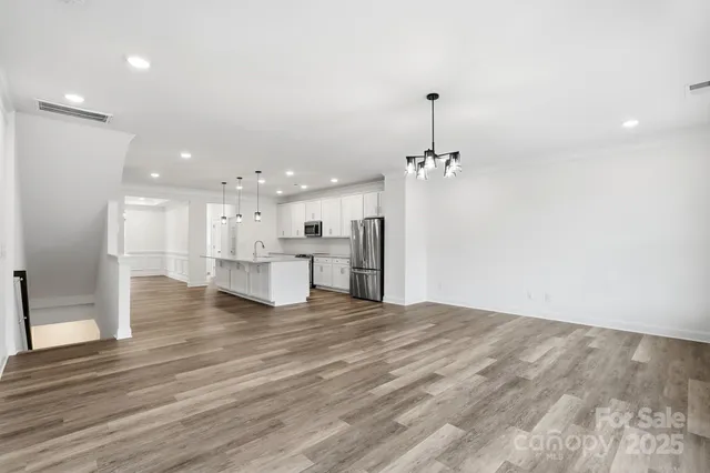 a view of a kitchen with a sink and chandelier