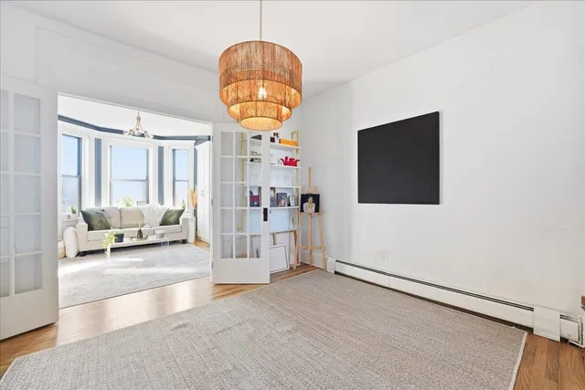 a living room with furniture and a chandelier