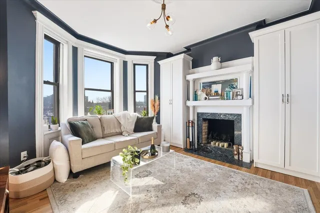 a living room with furniture and a fireplace