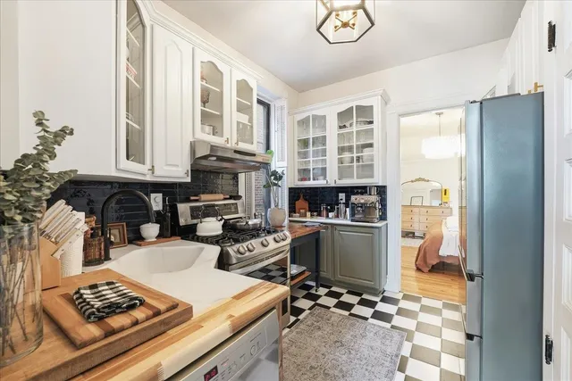 a kitchen with a refrigerator and a stove