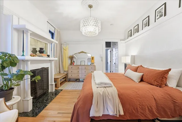 a bedroom with a bed and a fireplace