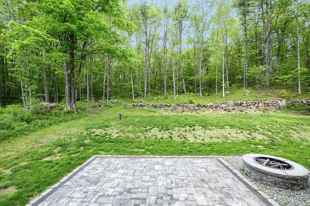 1310 North Brookfield Road Oakham, MA 01068 - Photo 7 of 30 a view of a garden with a pathway