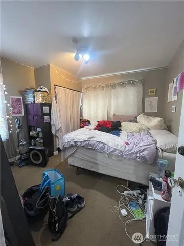 a bedroom with bed and a tv