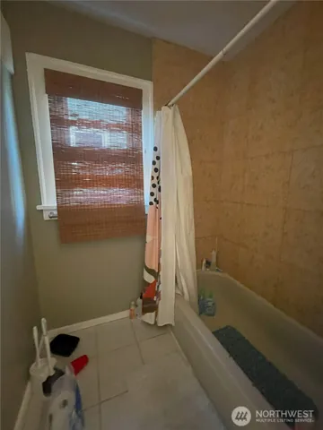 a bathroom with a bathtub and shower