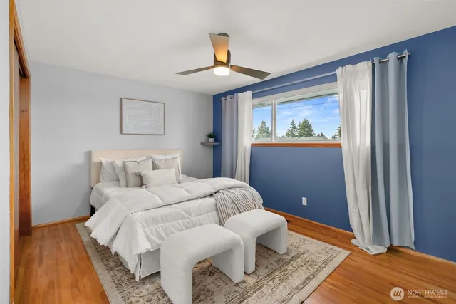 a bathroom with a sink a toilet a mirror and shower