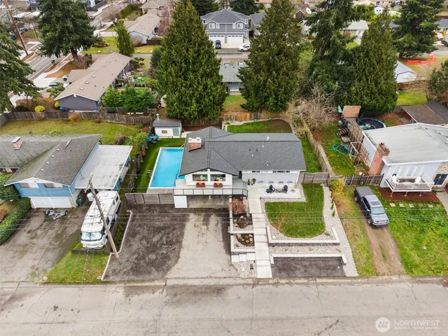 an aerial view of a house with a yard basket ball court and outdoor seating