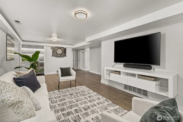 a view of an empty room with closet and a window