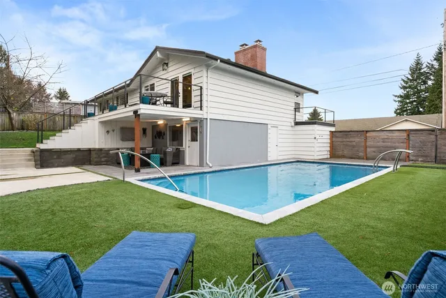 a view of a house with a yard and table