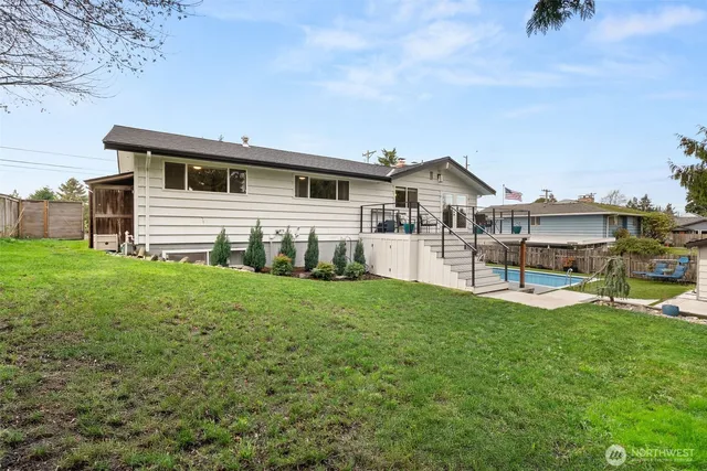 a view of a house with a yard and sitting area
