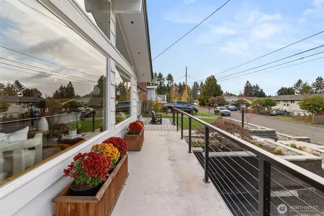 a view of a patio with table and chairs potted plants with wooden fence