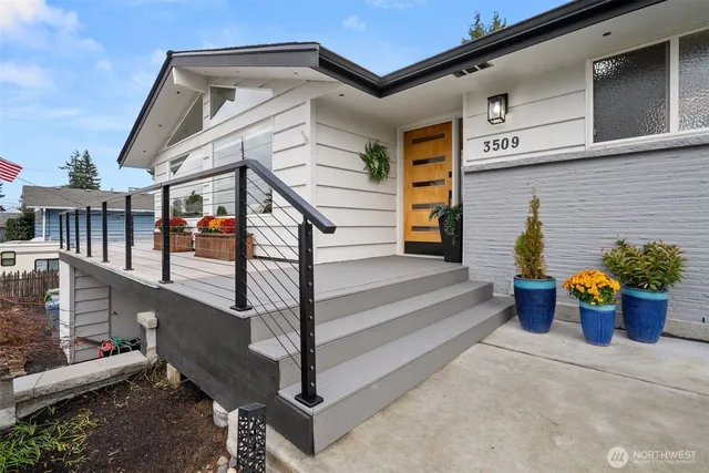 a very nice looking dining room with a large window and chandelier