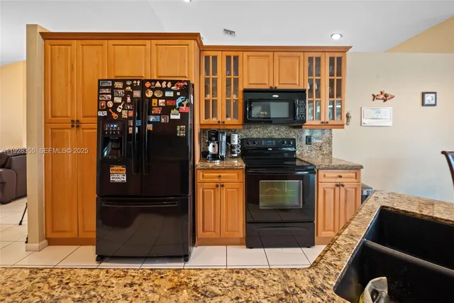 a kitchen with a refrigerator stove and a sink