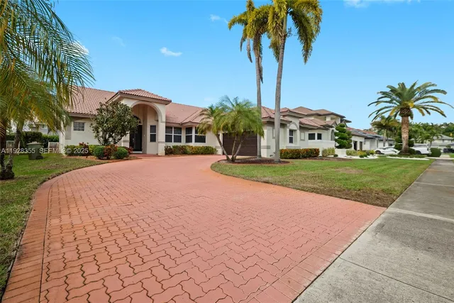a front view of multiple houses with yard