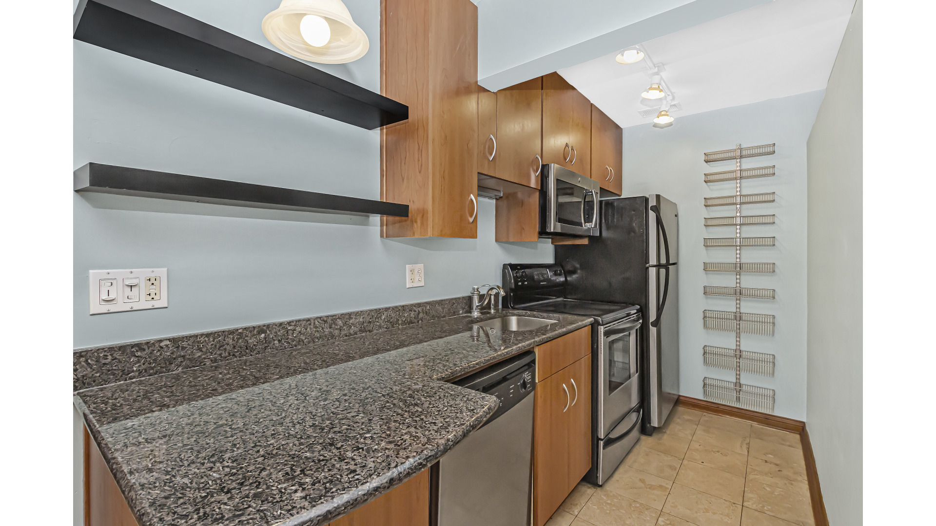 512 West Barry Avenue, Unit 408 Chicago, IL 60657 - Photo 12 of 21 a kitchen with stainless steel appliances granite countertop a sink stove and refrigerator