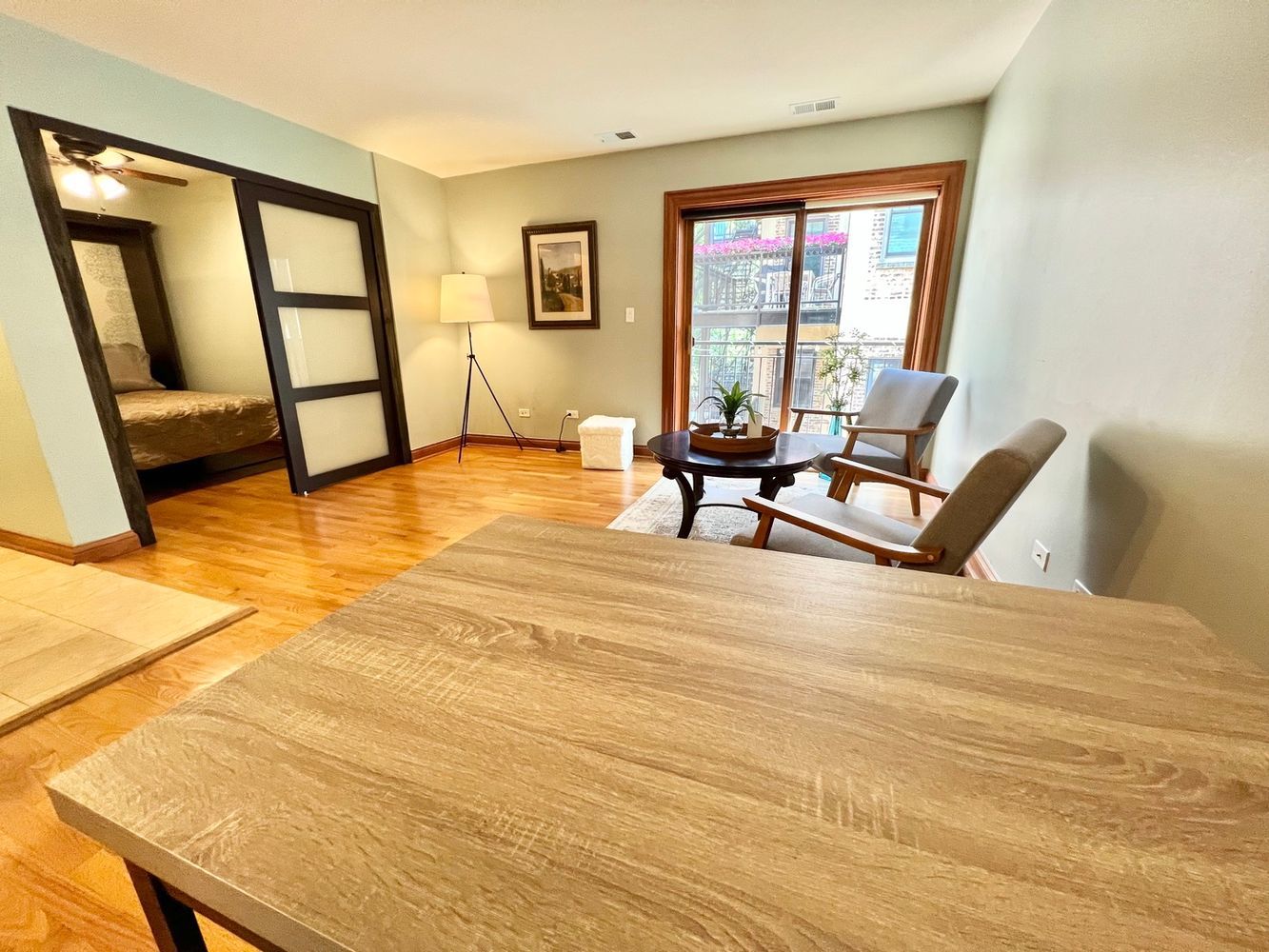 512 West Barry Avenue, Unit 408 Chicago, IL 60657 - Photo 4 of 21 a view of an empty room with window and wooden floor