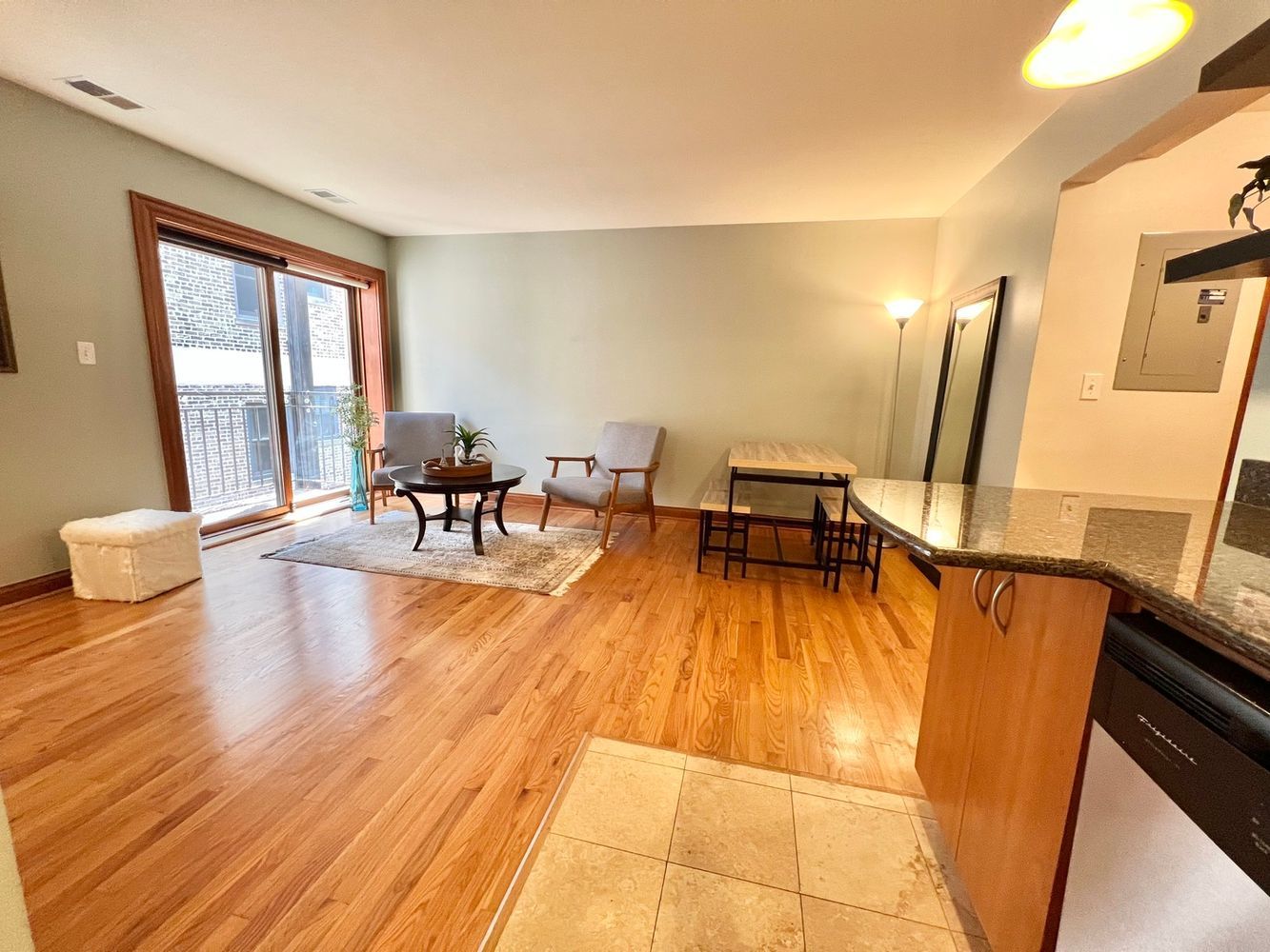 512 West Barry Avenue, Unit 408 Chicago, IL 60657 - Photo 5 of 21 a dining room with wooden floor and a floor to ceiling window
