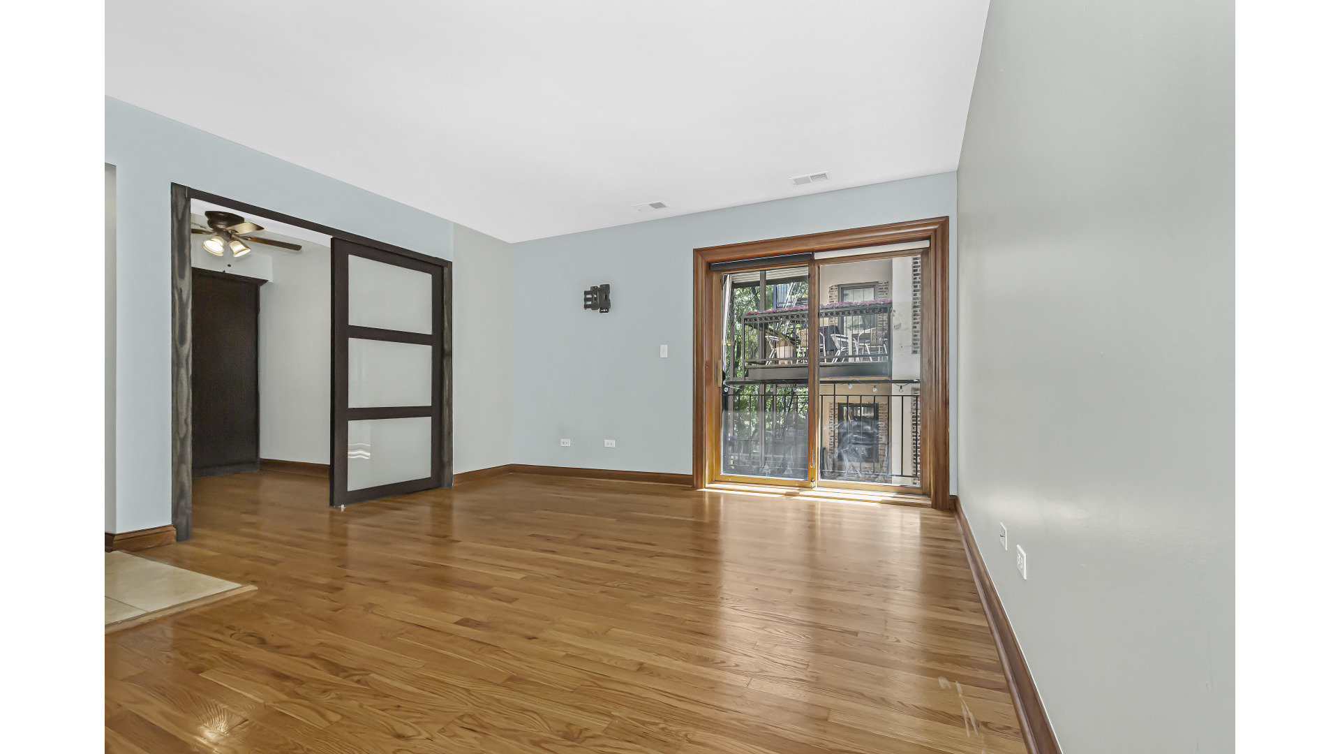 512 West Barry Avenue, Unit 408 Chicago, IL 60657 - Photo 8 of 21 an empty room with wooden floor and windows