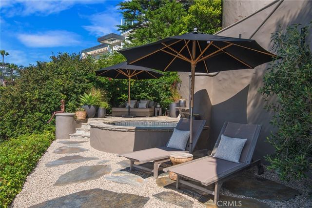 a view of a patio with table and chairs under an umbrella