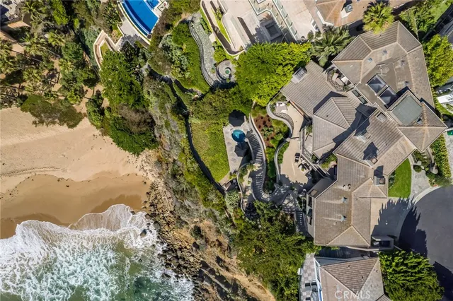an aerial view of a house with a yard and lake view