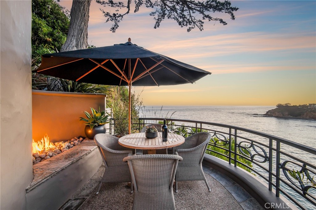 199 Emerald Bay Laguna Beach, CA 92651 - Photo 30 of 33 an outdoor space with furniture and umbrella