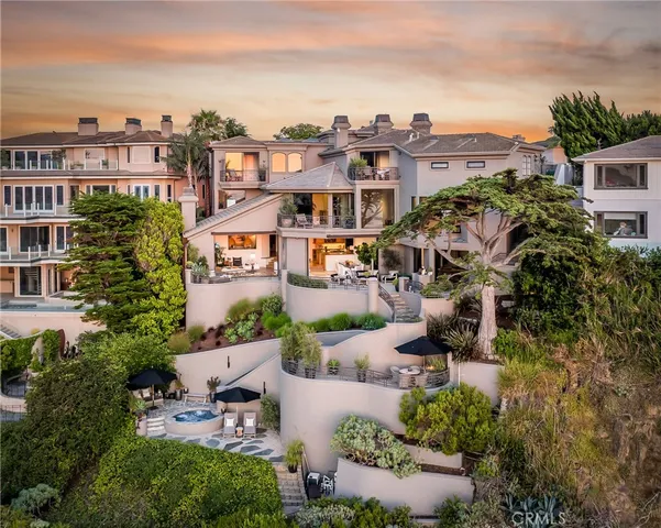 an aerial view of multiple houses with a yard