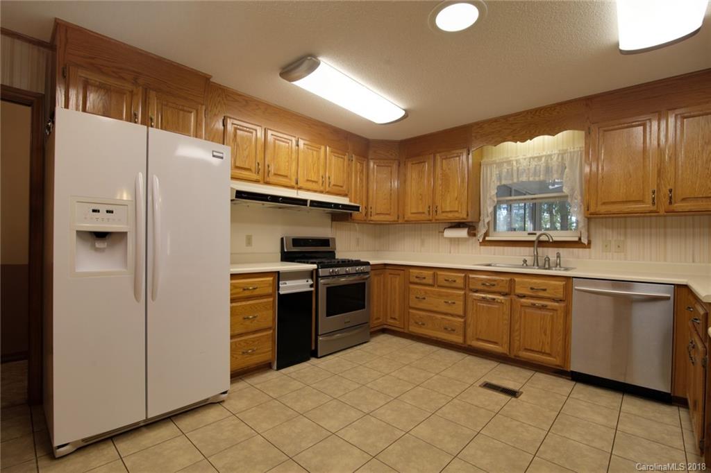 503 Jim Dobbins Road Rutherfordton, NC 28139 - Photo 14 of 34 a kitchen with stainless steel appliances granite countertop a refrigerator sink and cabinets