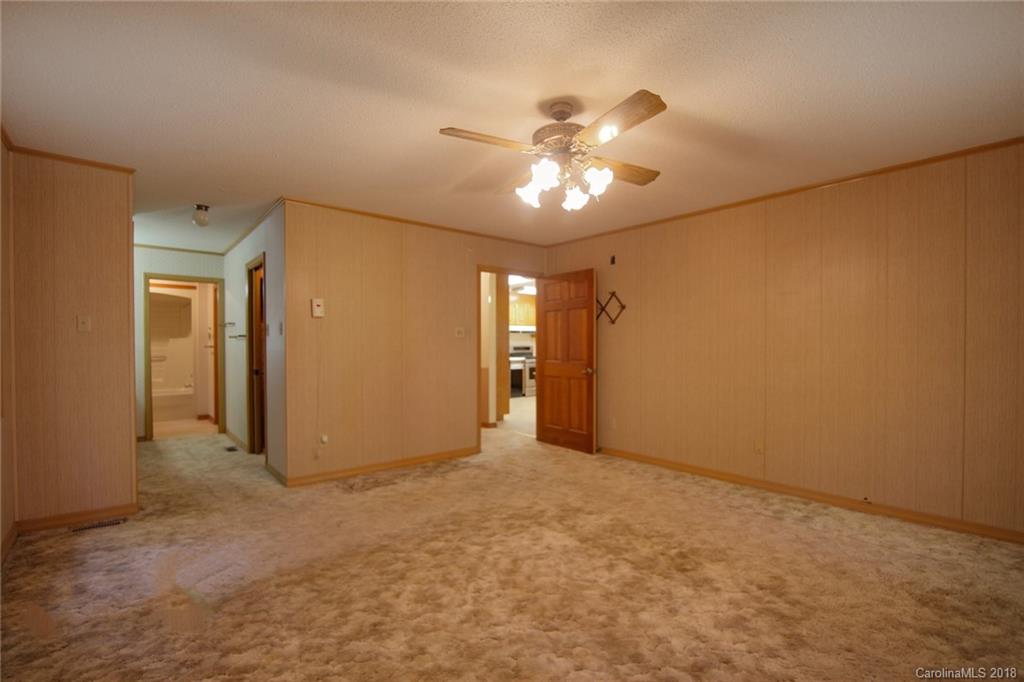 503 Jim Dobbins Road Rutherfordton, NC 28139 - Photo 18 of 34 a view of an empty room with a chandelier fan