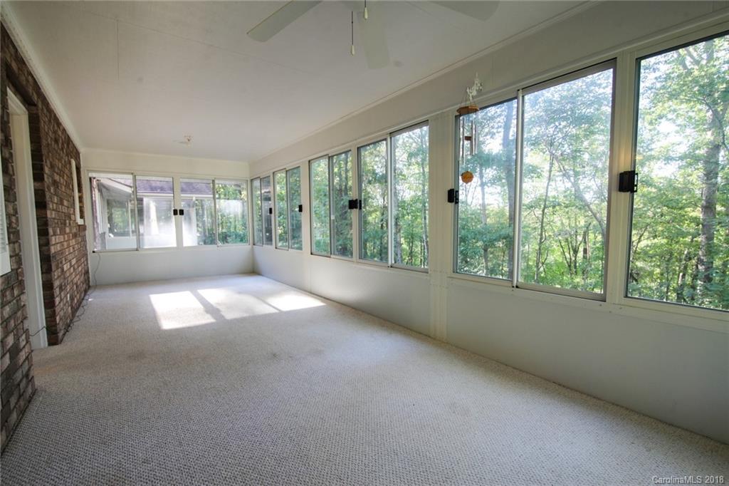 503 Jim Dobbins Road Rutherfordton, NC 28139 - Photo 19 of 34 a view of empty room with floor to ceiling window and an outdoor view