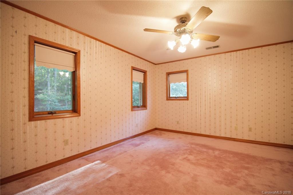 503 Jim Dobbins Road Rutherfordton, NC 28139 - Photo 23 of 34 an empty room with windows and fan