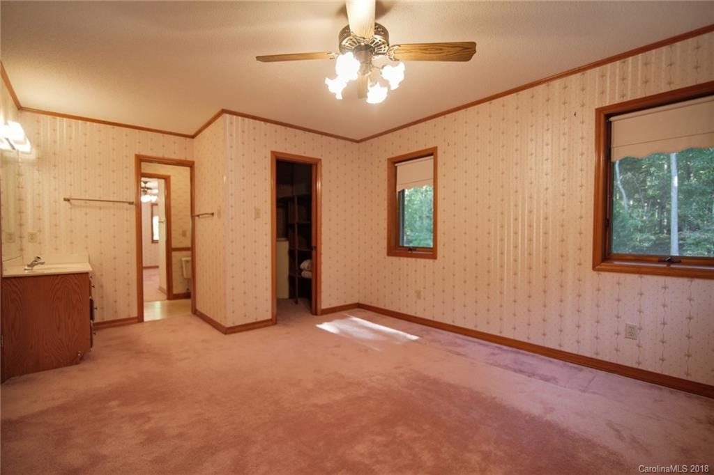 503 Jim Dobbins Road Rutherfordton, NC 28139 - Photo 24 of 34 an empty room with chandelier fan and windows