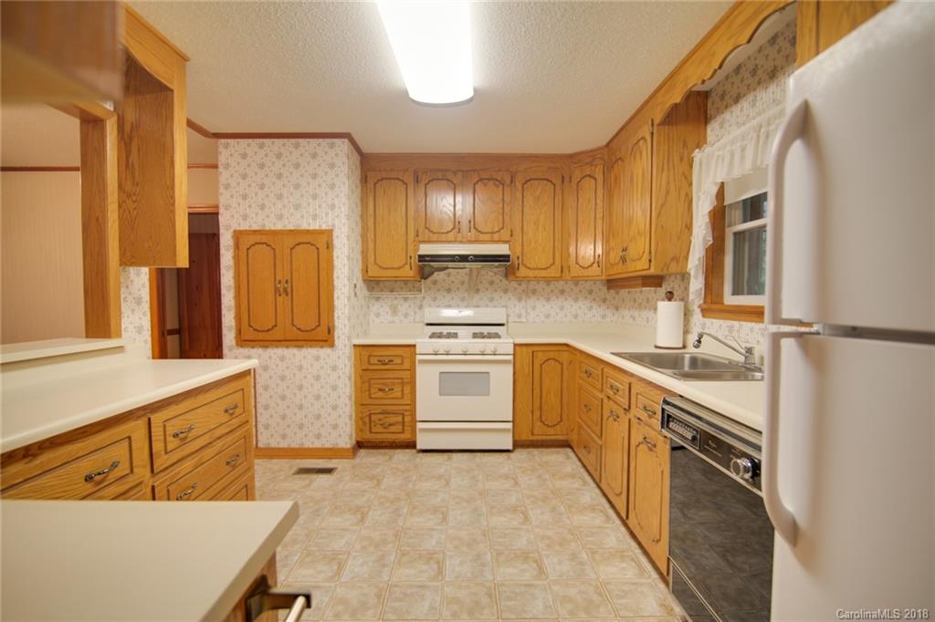 503 Jim Dobbins Road Rutherfordton, NC 28139 - Photo 4 of 34 a kitchen with stainless steel appliances granite countertop a stove a sink and a refrigerator