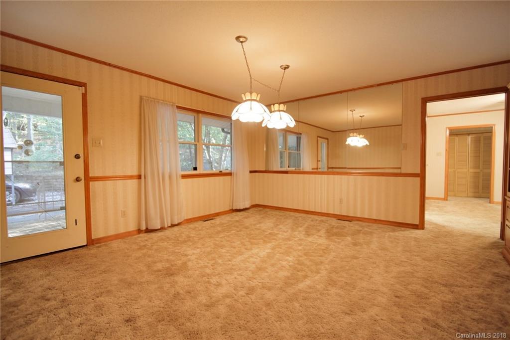 503 Jim Dobbins Road Rutherfordton, NC 28139 - Photo 8 of 34 an empty room with a window and chandelier