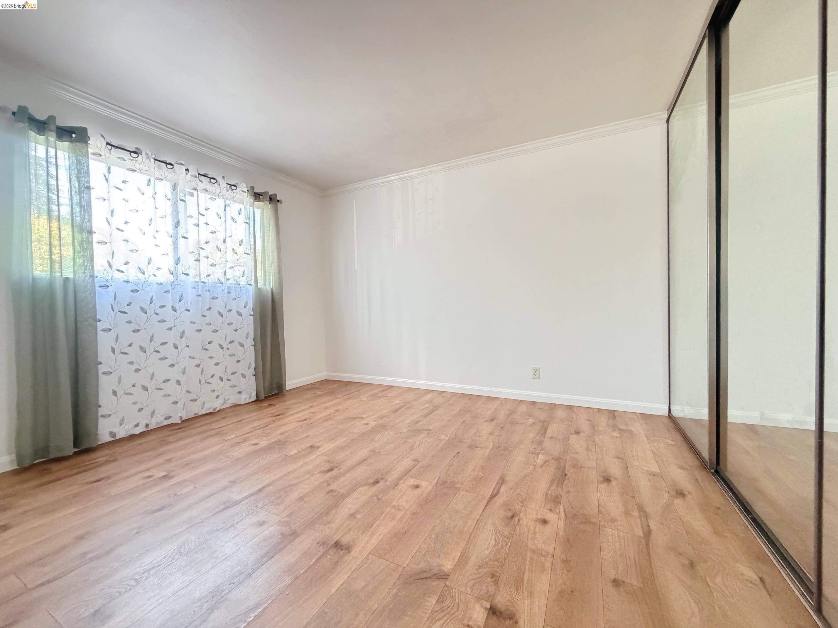 9085 Alcosta Boulevard, Unit 331 San Ramon, CA 94583 - Photo 11 of 18 Unfurnished bedroom with light wood-style flooring, ornamental molding, and a closet
