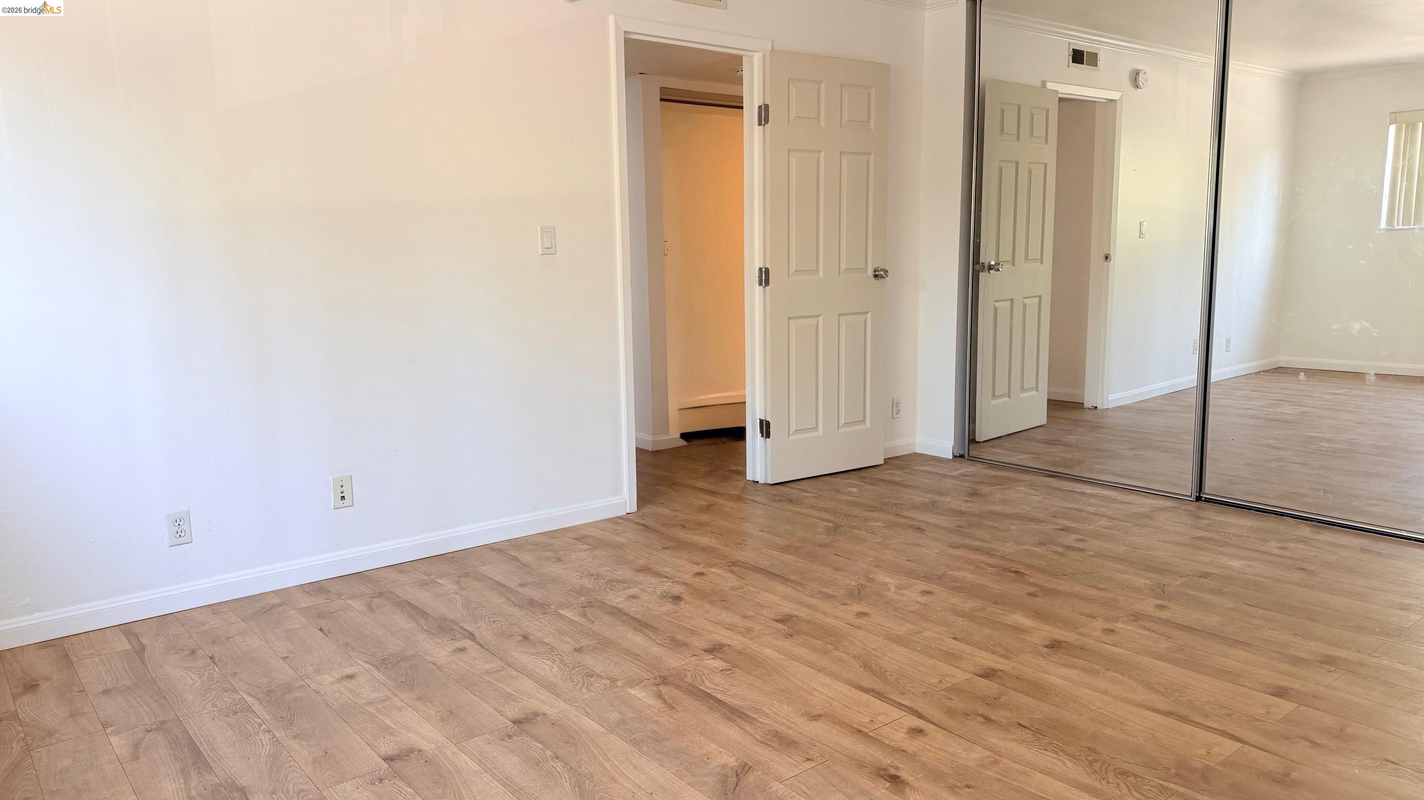 9085 Alcosta Boulevard, Unit 331 San Ramon, CA 94583 - Photo 12 of 18 Unfurnished bedroom with light wood finished floors, a closet, and ornamental molding
