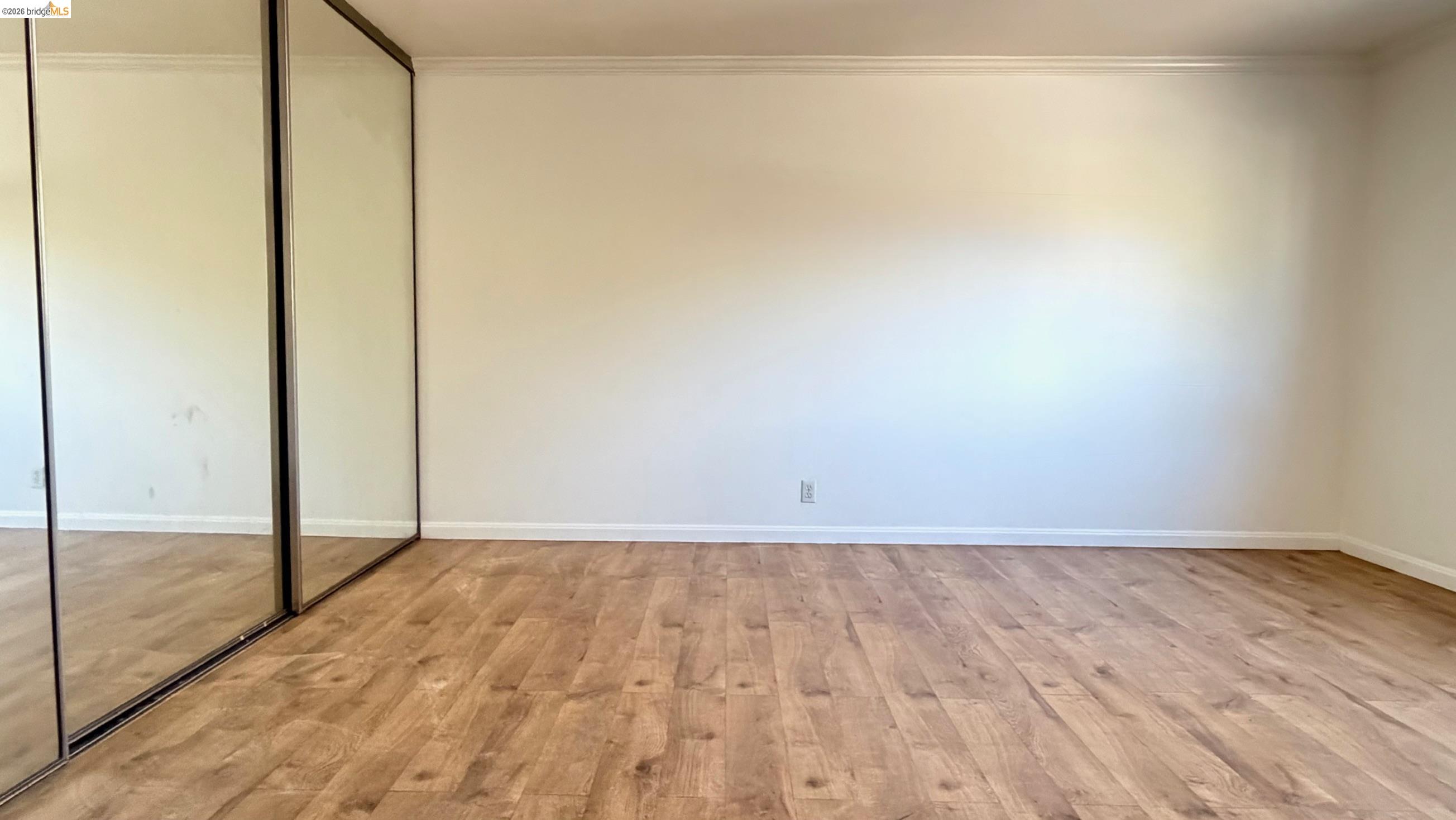 9085 Alcosta Boulevard, Unit 331 San Ramon, CA 94583 - Photo 13 of 18 Unfurnished bedroom featuring light wood-style flooring, a closet, and crown molding