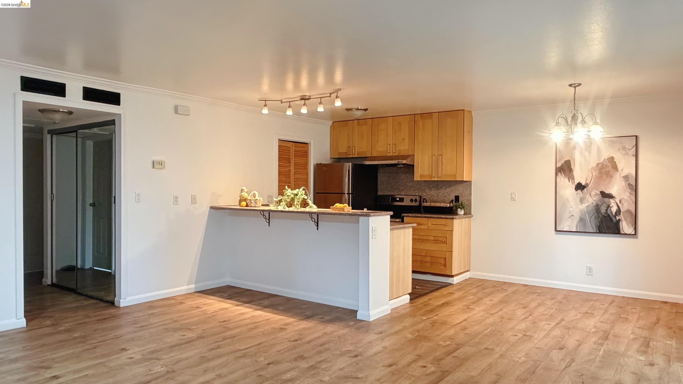 9085 Alcosta Boulevard, Unit 331 San Ramon, CA 94583 - Photo 2 of 18 Kitchen featuring a peninsula, a breakfast bar area, stainless steel appliances, decorative backsplash, and hanging lights