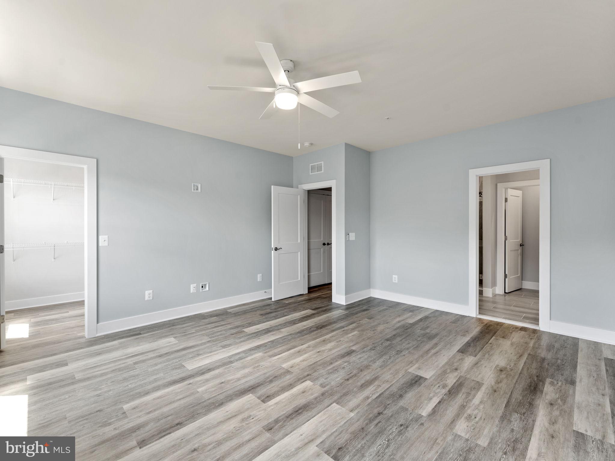 1616 Bandit Loop, Unit 10B Reston, VA 20190 - Photo 14 of 24 a view of an empty room with wooden floor and a ceiling fan