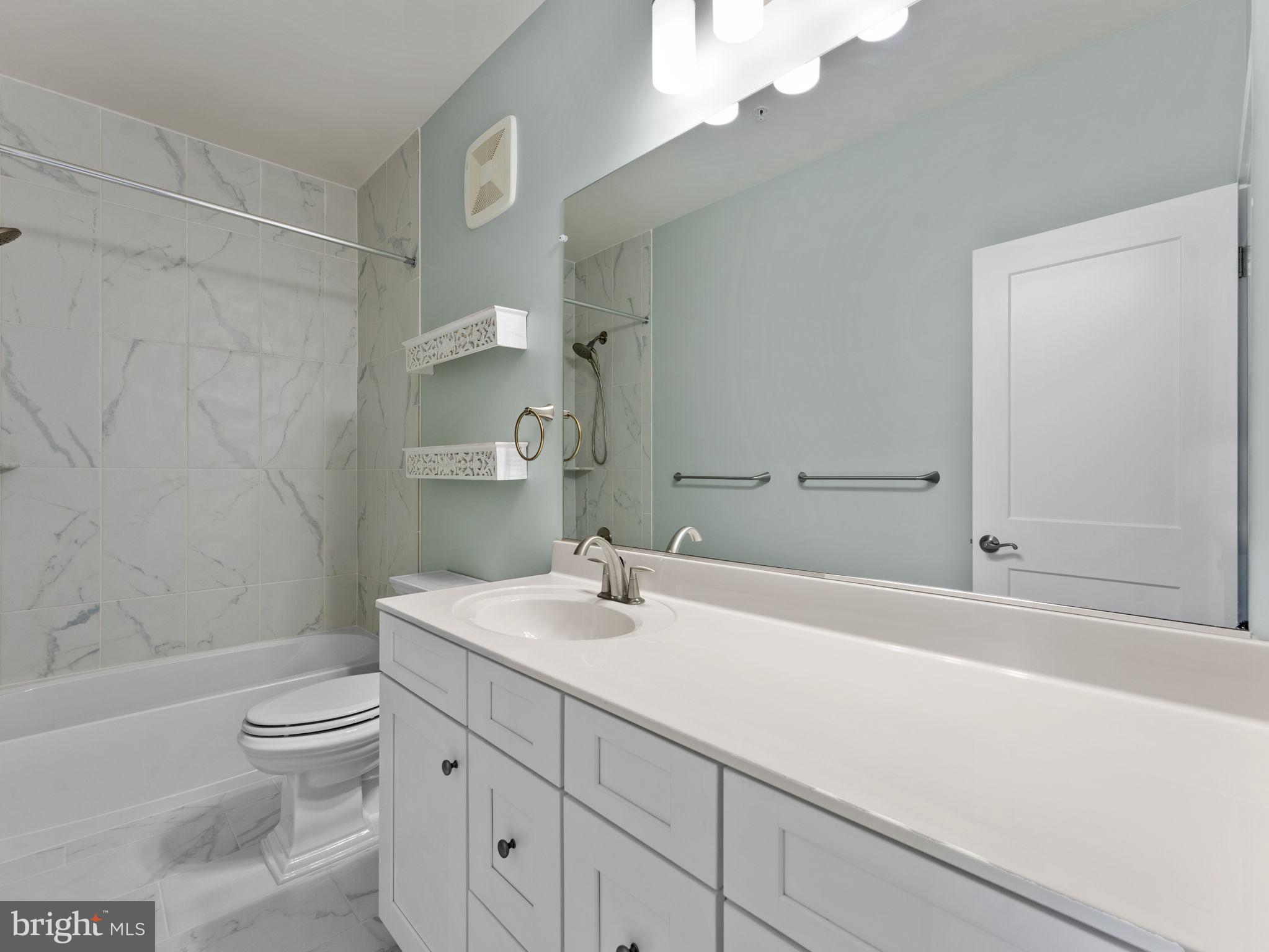 1616 Bandit Loop, Unit 10B Reston, VA 20190 - Photo 17 of 24 a bathroom with a sink a toilet and shower