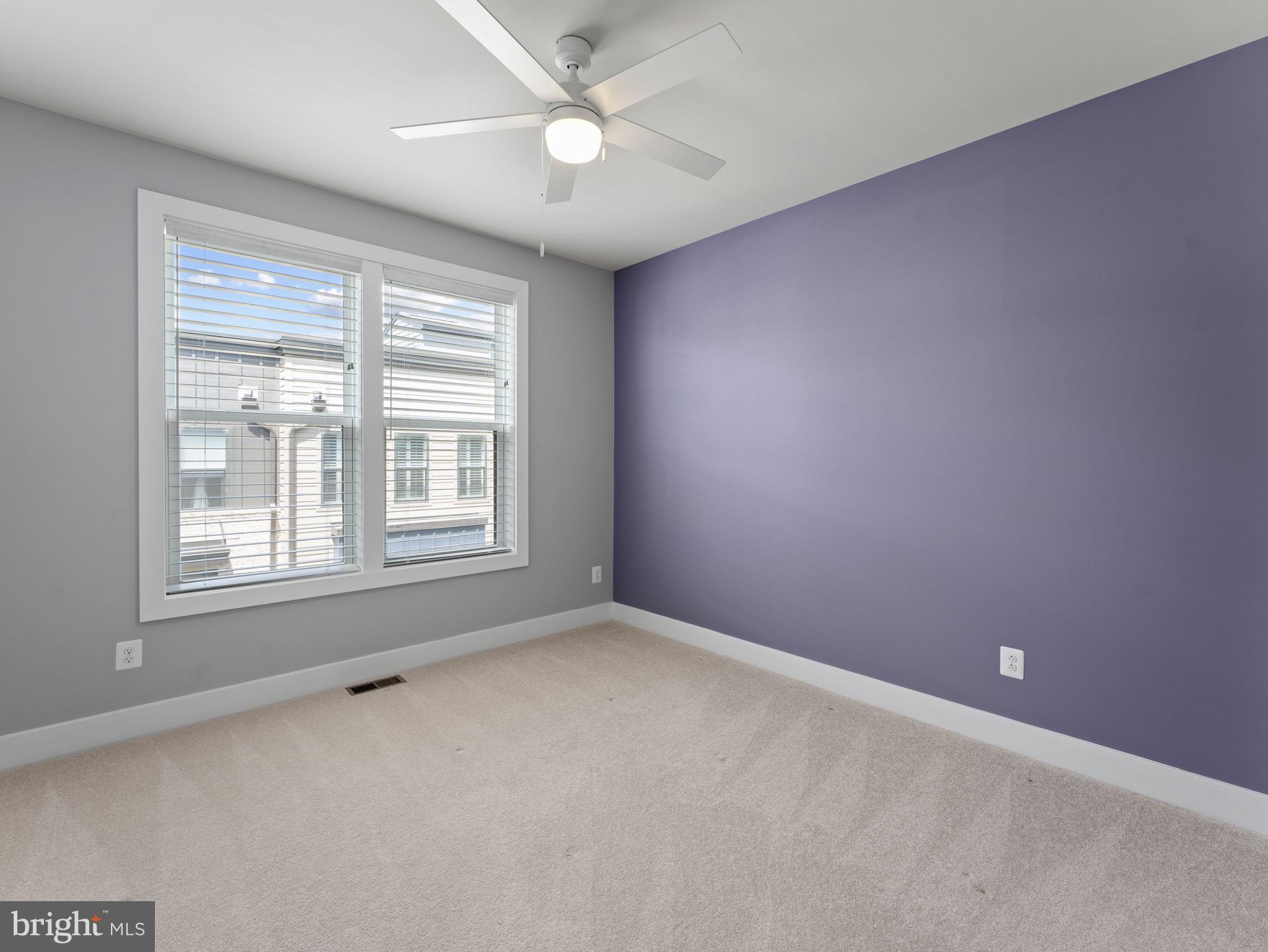 1616 Bandit Loop, Unit 10B Reston, VA 20190 - Photo 20 of 24 en empty room with windows and ceiling fan