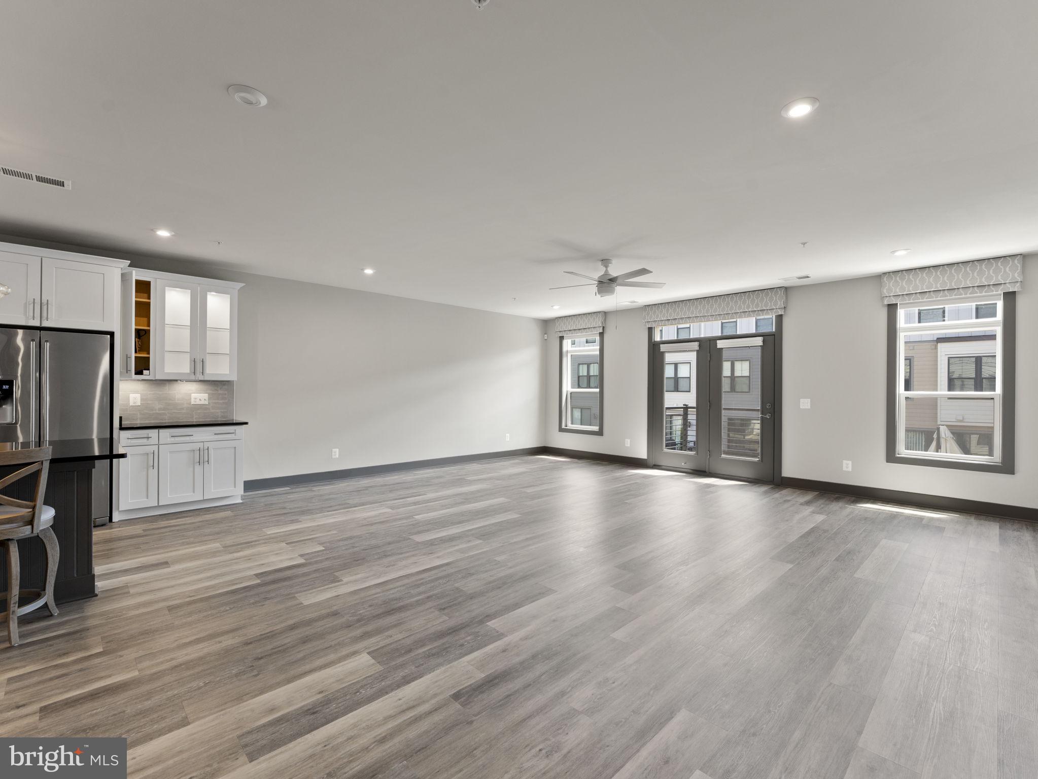 1616 Bandit Loop, Unit 10B Reston, VA 20190 - Photo 2 of 24 a view of an empty room with a window and wooden floor
