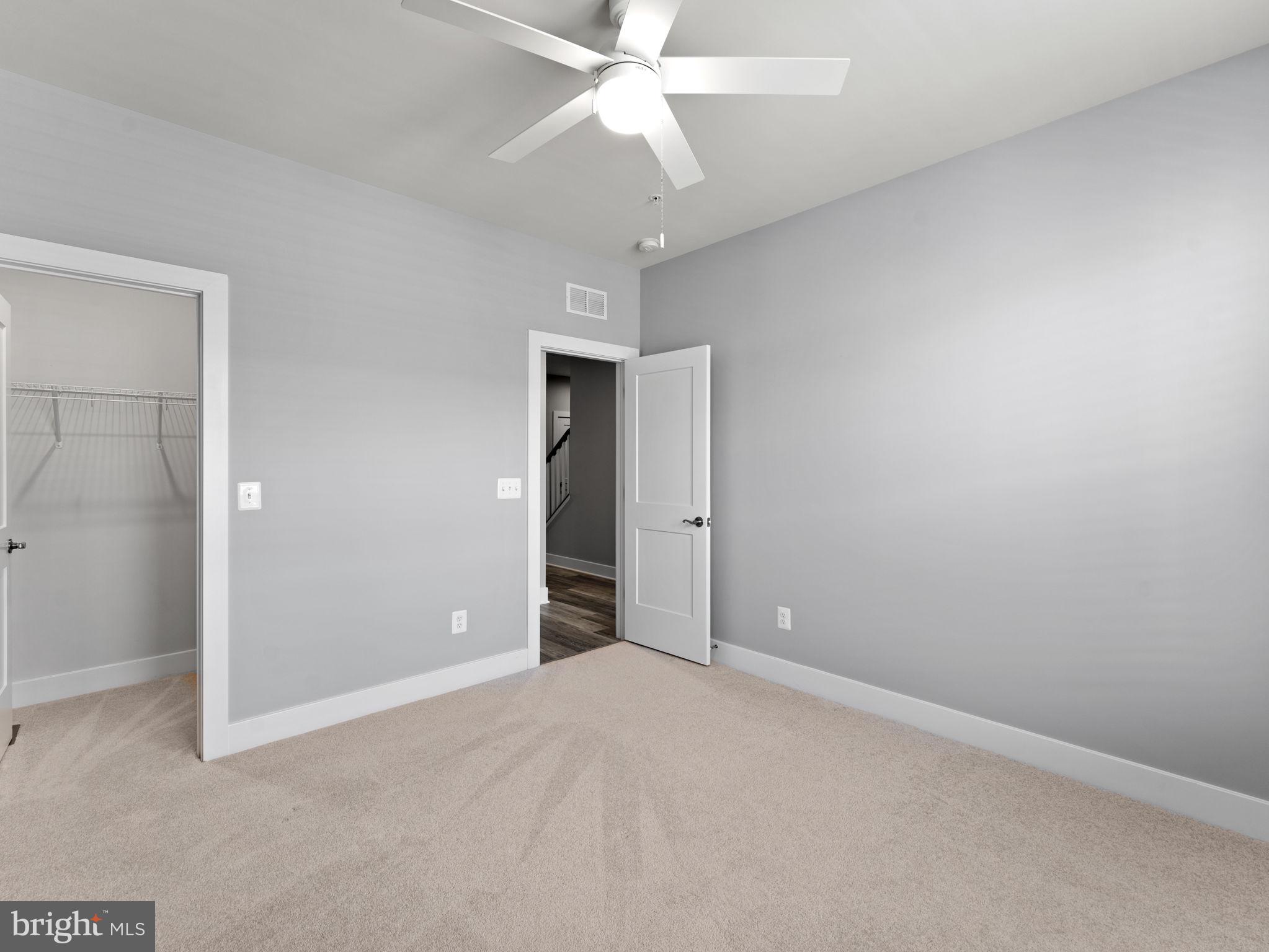 1616 Bandit Loop, Unit 10B Reston, VA 20190 - Photo 21 of 24 an empty room with closet and a chandelier fan