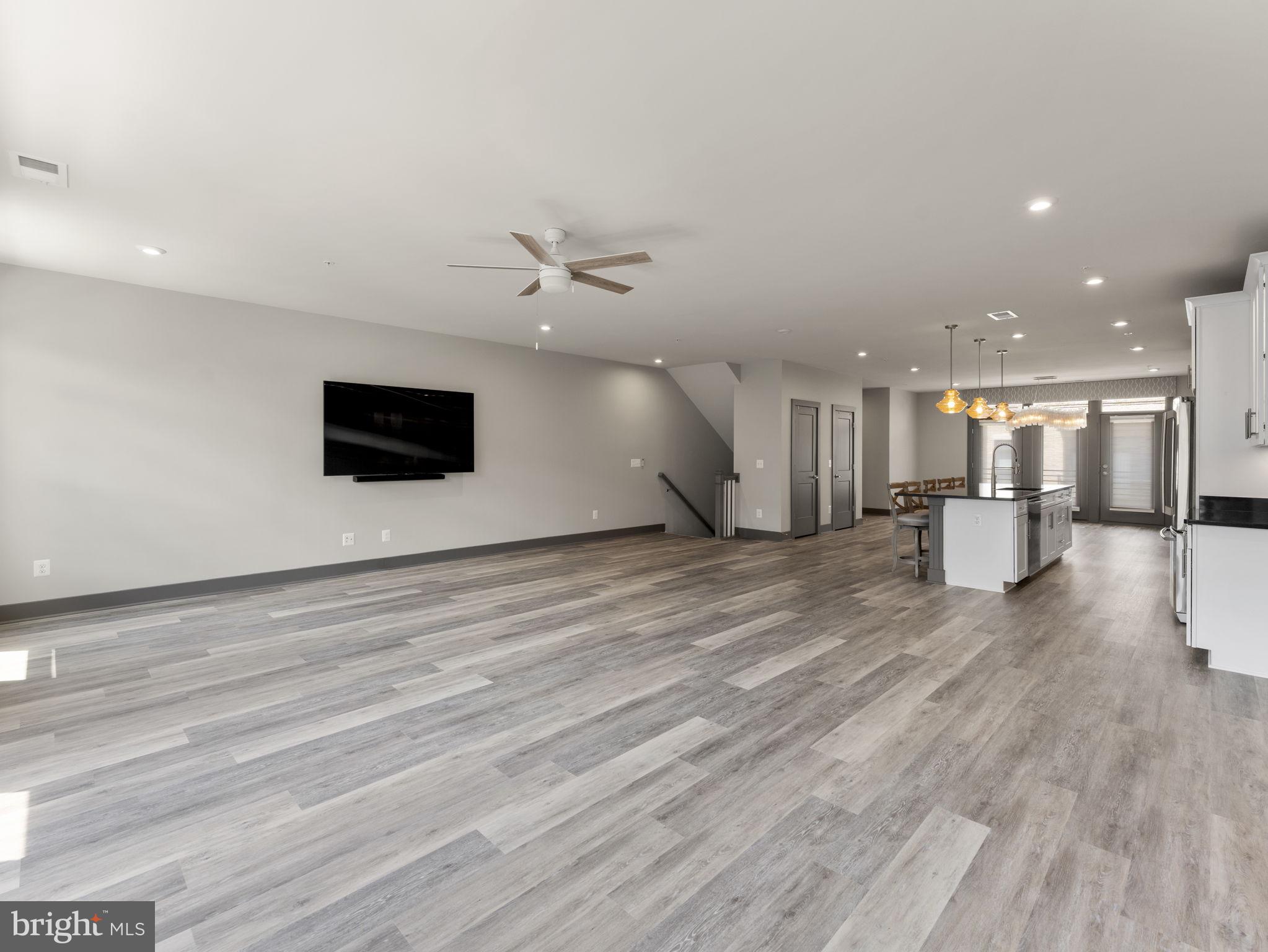 1616 Bandit Loop, Unit 10B Reston, VA 20190 - Photo 4 of 24 a view of an empty room with wooden floor and a kitchen