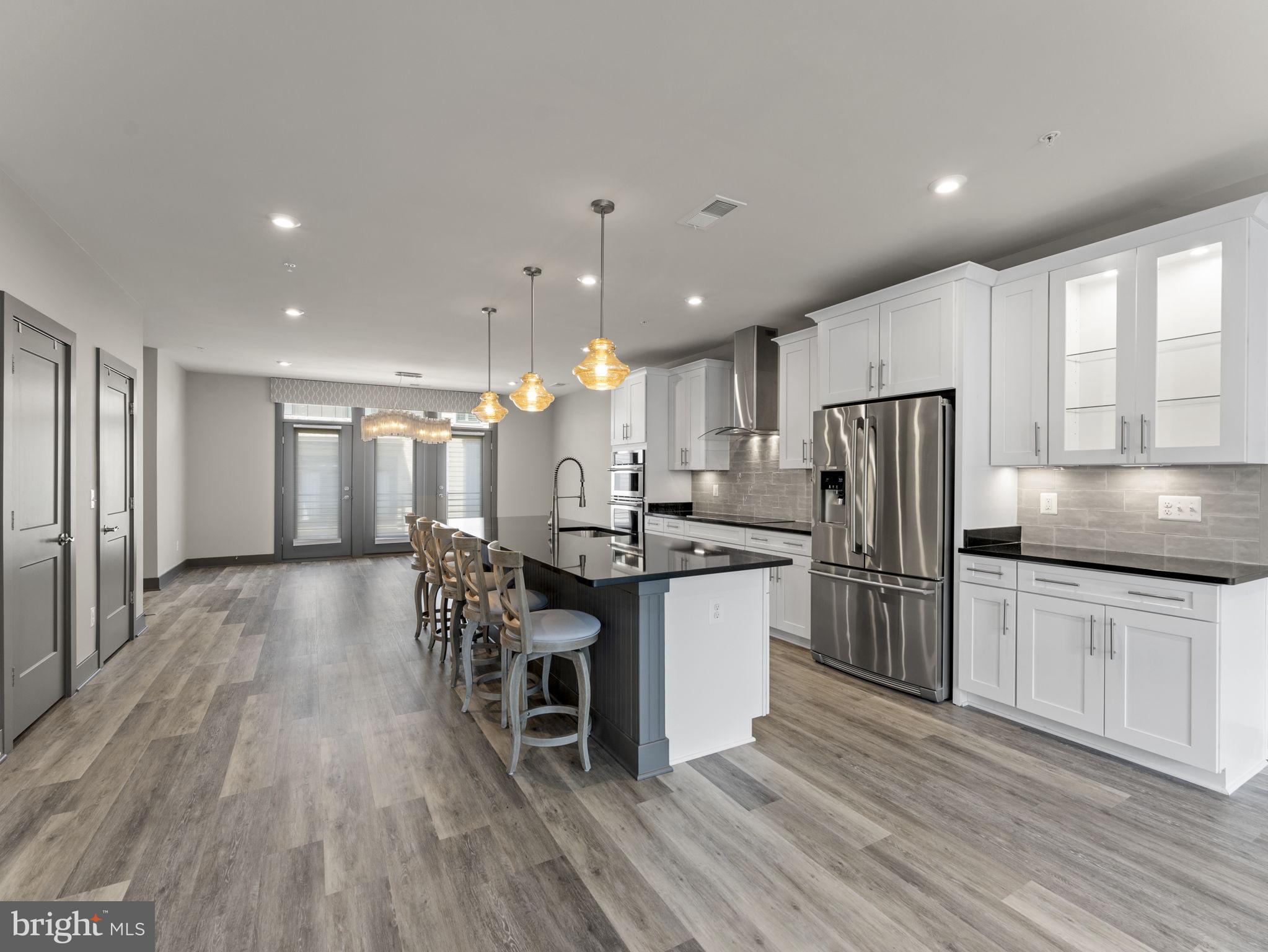 1616 Bandit Loop, Unit 10B Reston, VA 20190 - Photo 6 of 24 a kitchen with stainless steel appliances a refrigerator a stove a sink dishwasher with a dining table and chairs