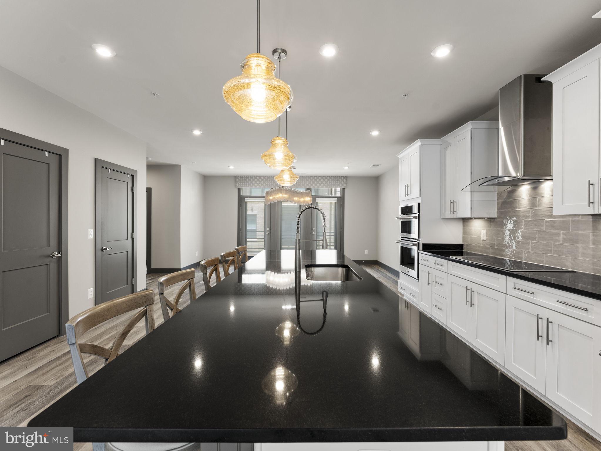 1616 Bandit Loop, Unit 10B Reston, VA 20190 - Photo 7 of 24 a large kitchen with stainless steel appliances a large counter top a stove and a sink