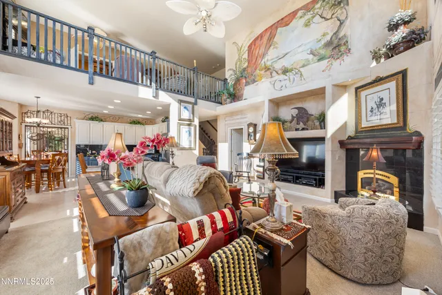 a living room with furniture a fireplace and a chandelier