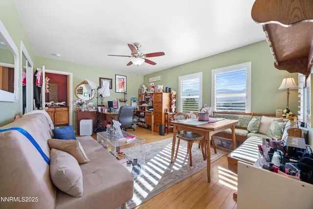 a living room with furniture kitchen view and a large window