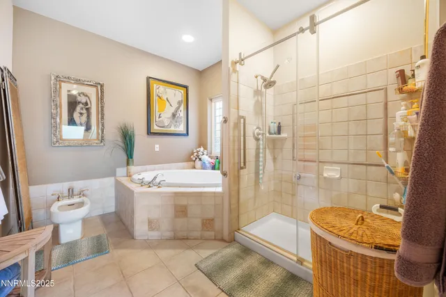 a bathroom with a granite countertop bathtub and a shower
