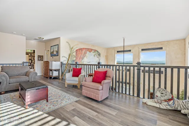 a living room with furniture a rug and a chandelier